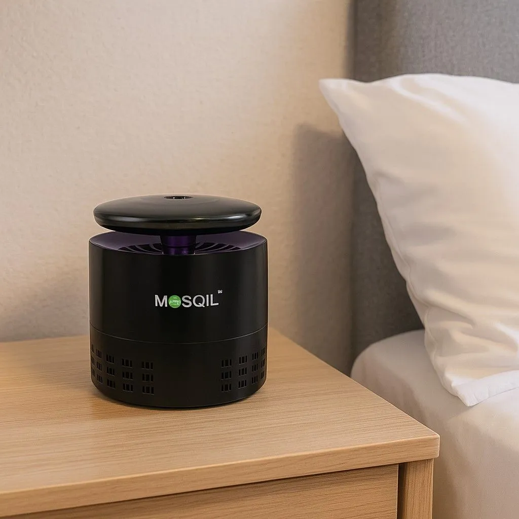 Mosqil mosquito killer machine placed on a bedside table in a bedroom setting.